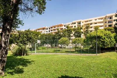 a park with a large building in the background at Apartamento da Silva by An Island Apart in Funchal