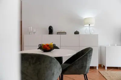 a table and chairs with a bowl of fruit on it at Apartamento da Silva by An Island Apart in Funchal