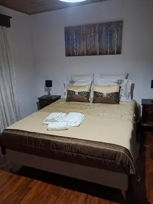 a bedroom with a large bed with two towels on it at Casa Sequeira in Fajã da Ovelha