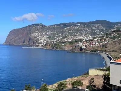 a view of a body of water with a city at Sunset Ocean View Apartment in Funchal