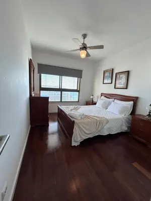 a bedroom with a bed and a ceiling fan at Sunset Ocean View Apartment in Funchal