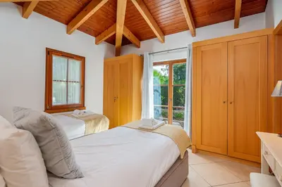 two beds in a room with a window at Peaceful and lovely retreat with a pool #1982 in Barão de São Miguel