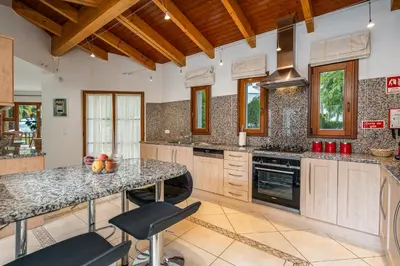 a kitchen with a large island in a room at Peaceful and lovely retreat with a pool #1982 in Barão de São Miguel