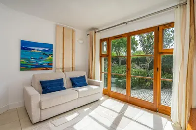 a living room with a couch and a window at Peaceful and lovely retreat with a pool #1982 in Barão de São Miguel