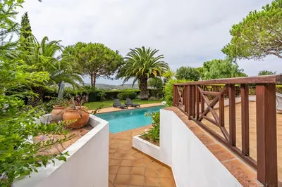 a backyard with a swimming pool and a wooden bridge at Peaceful and lovely retreat with a pool #1982 in Barão de São Miguel