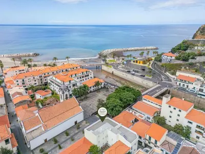 an aerial view of a city with the ocean at Rumo by KAAMAH in Ribeira Brava
