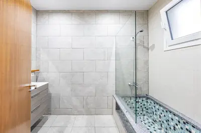 a bathroom with a shower with a glass door at Ricardo's Village by YOUR KEY in Porto da Cruz
