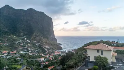 a town on a hill next to the ocean at Ricardo's Village by YOUR KEY in Porto da Cruz