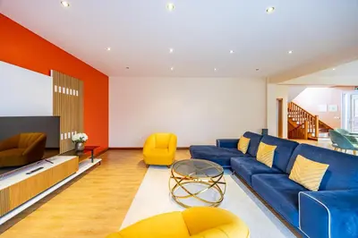 a living room with a blue couch and yellow chairs at Ricardo's Village by YOUR KEY in Porto da Cruz