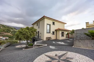 a villa with a driveway in front of a house at Ricardo's Village by YOUR KEY in Porto da Cruz