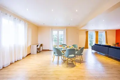 a dining room with a table and chairs and a couch at Ricardo's Village by YOUR KEY in Porto da Cruz