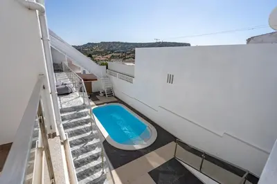 a balcony with a pool on the side of a building at Aurazul Apartment in Luz