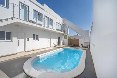 a swimming pool in the backyard of a house at Aurazul Apartment in Luz
