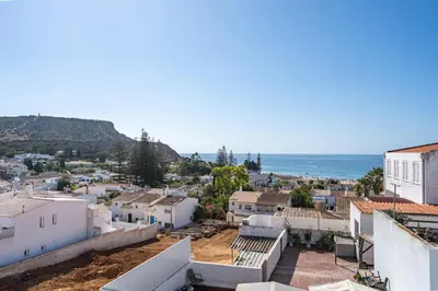 a view of a city with the ocean in the background at Aurazul Apartment in Luz