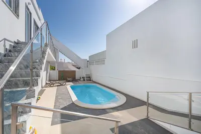 a swimming pool on the side of a building at Aurazul Apartment in Luz
