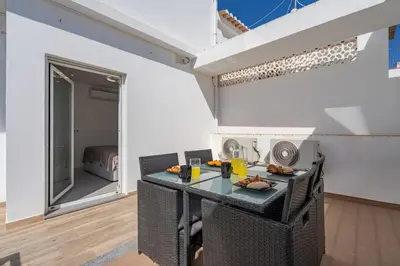 a small kitchen with a table and chairs at Aurazul Apartment in Luz