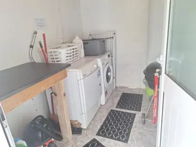 a laundry room with a washer and a washing machine at Lovely house on Santa Maria Island Azores in Santa Bárbara