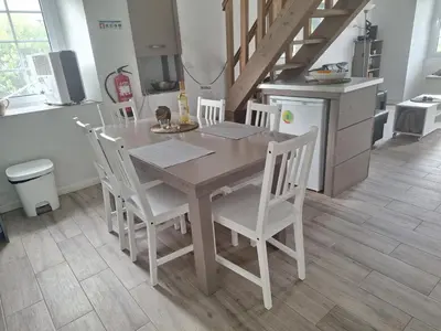 a wooden table and chairs in a kitchen at Lovely house on Santa Maria Island Azores in Santa Bárbara
