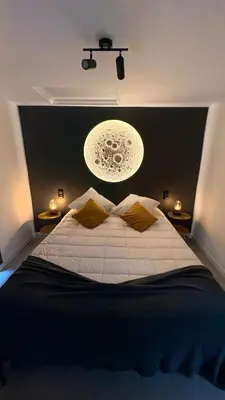 a bedroom with a large bed with a light above it at Old Aqueduct Village 1 - Guesthouse - Madeira in Serra de Água