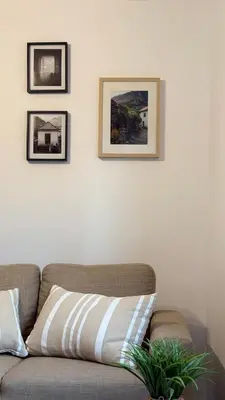 a couch in a living room with pictures on the wall at Old Aqueduct Village 1 - Guesthouse - Madeira in Serra de Água