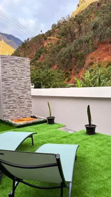 a patio with green grass and a bench at Old Aqueduct Village 1 - Guesthouse - Madeira in Serra de Água