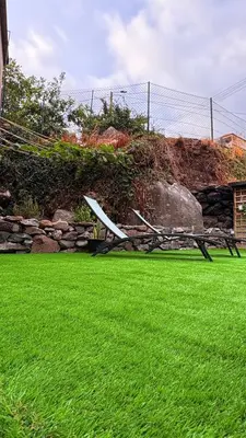 a bench sitting on the grass in a yard at Old Aqueduct Village 1 - Guesthouse - Madeira in Serra de Água