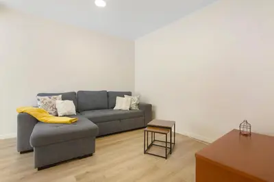 a living room with a couch and a table at Moradia Centro Da Cidade Funchal in Funchal