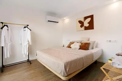 a bedroom with a bed and a large window at Green Shelter - Guest House in Santana