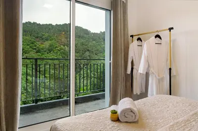 a sliding glass door with a view of a balcony at Green Shelter - Guest House in Santana