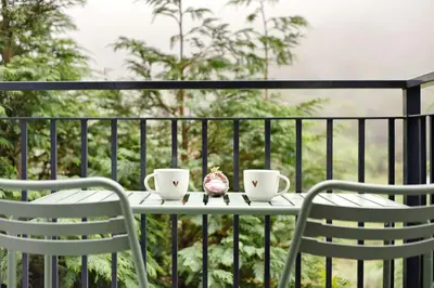 two chairs and a table on a balcony at Green Shelter - Guest House in Santana