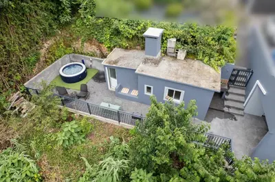 a model of a blue house with a yard at Green Shelter - Guest House in Santana