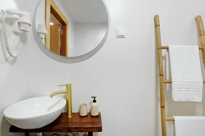 a bathroom with a sink and a mirror at Green Shelter - Guest House in Santana