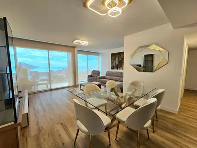 a living room with a glass table and chairs at Beautiful View by Rentallido in Funchal