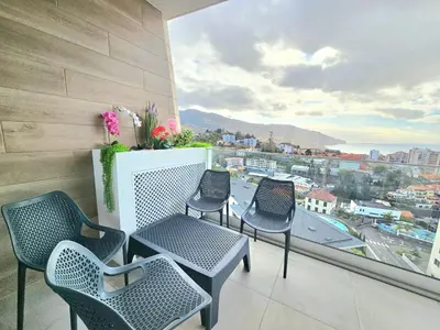 a balcony with chairs and a table with a view at Beautiful View by Rentallido in Funchal