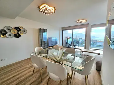 a dining room with a glass table and chairs at Beautiful View by Rentallido in Funchal