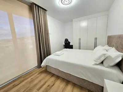 a bedroom with a large white bed and a window at Beautiful View by Rentallido in Funchal