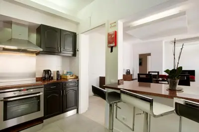 a kitchen with black cabinets and a counter top at Funchal Centre Bliss -Soulful Stays in Funchal