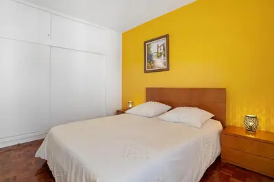 a bedroom with a white bed and a yellow wall at Funchal Centre Bliss -Soulful Stays in Funchal