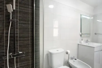 a bedroom with a bed and a dresser and a mirror at Funchal Centre Bliss -Soulful Stays in Funchal