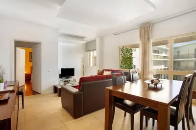 a living room with a table and a couch at Funchal Centre Bliss -Soulful Stays in Funchal