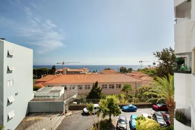 a view of a building with cars parked in a parking lot at Funchal Centre Bliss -Soulful Stays in Funchal