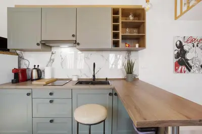 a kitchen with white cabinets and a wooden counter top at Seaside Haven - Soulful Stays in Porto Moniz