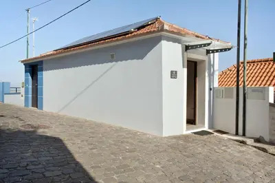 a small white building with a red roof at Seaside Haven - Soulful Stays in Porto Moniz