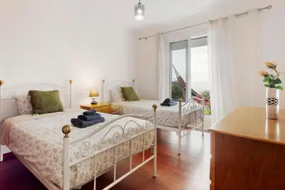 a bedroom with two beds and a window at Blissful Haven - Soulful Stays in Porto Moniz