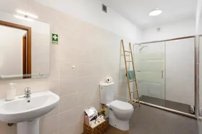 a bathroom with a toilet and a sink and a shower at Blissful Haven - Soulful Stays in Porto Moniz