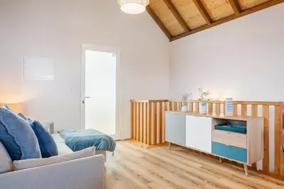a living room with a couch and a table at Palheiro Simone by Homie in Lanceiros
