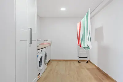 a laundry room with a washer and dryer at Palheiro Simone by Homie in Lanceiros