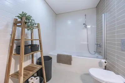 a bathroom with a toilet and a sink and a shower at Casa do Mar in Burgau