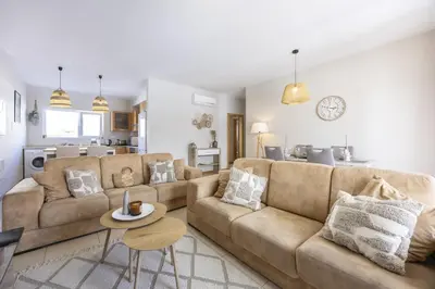 a living room with a couch and a table at Casa do Mar in Burgau