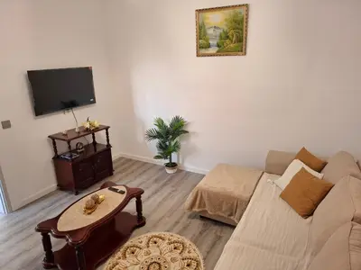 a white bedroom with a large bed and a window at Varanda Encantada House in Ponta do Sol